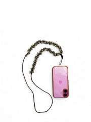 Arendelle Navratri Ghungroo Phone Sling attached to a pink phone case. Festive sling designed for cultural celebrations and phone carrying.