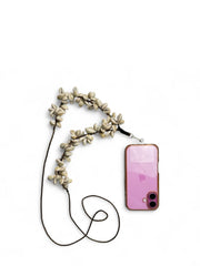 Ethnic Arendelle Phone Sling attached to a pink phone case, showcasing its festive Navratri design with cowrie shell embellishments.