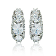Loop silver earrings with cubic zirconia and brass, featuring a symmetrical row of sparkling stones. Elegant jewelry for formal or casual wear.