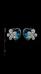 Close-up of Swarovski Blue Heart and Studded Flower Earrings with size reference, highlighting intricate crystal detailing and compact 1-inch design.
