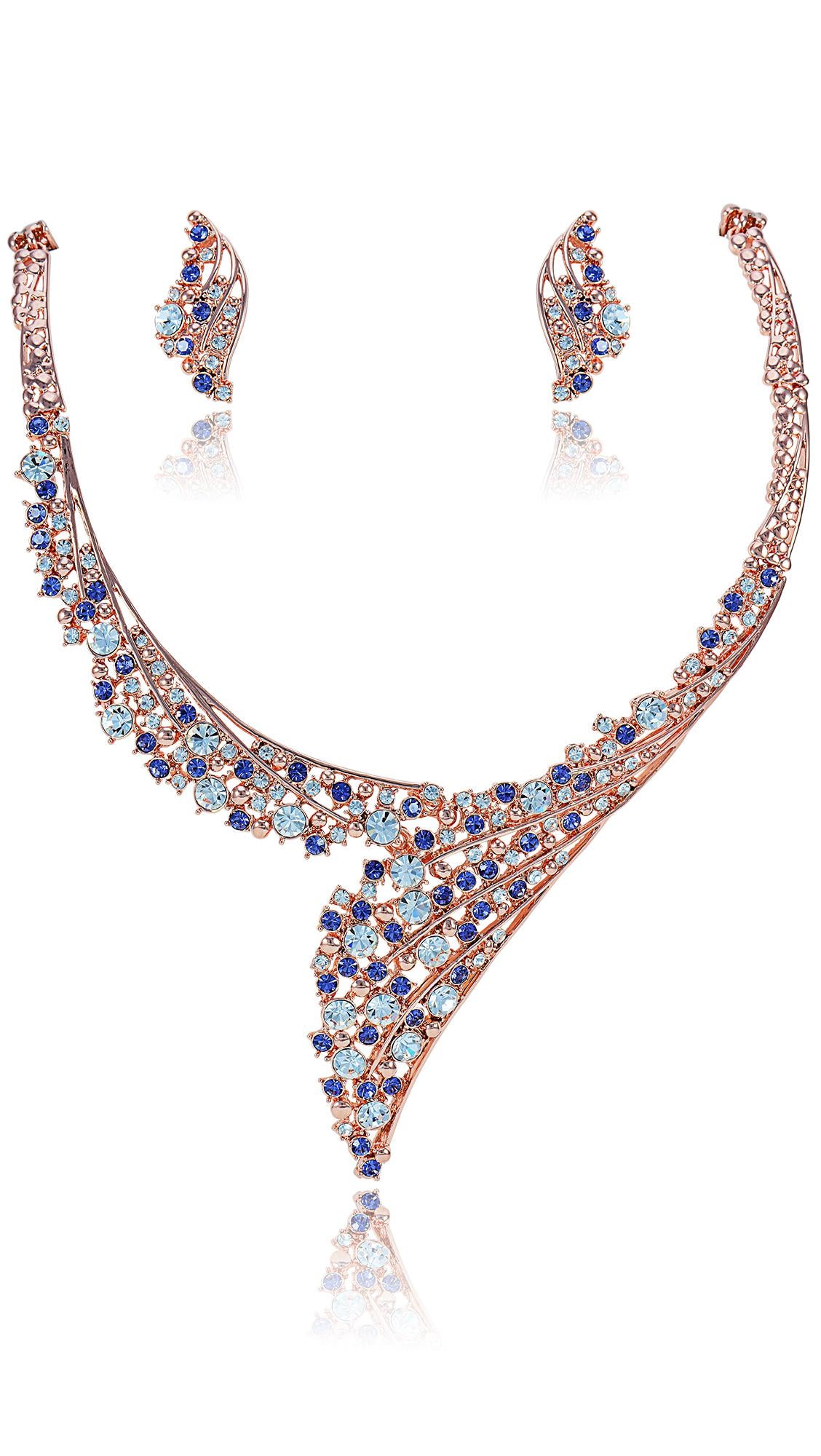 Crystal necklace and earrings set featuring colorful blue and purple stones in a rose gold finish. Elegant jewelry for formal or evening wear.