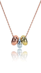 Concentric Opal Pendant necklace featuring rose gold, silver, and gold-tone circular charms on a delicate chain. Minimalist design for elegant wear.