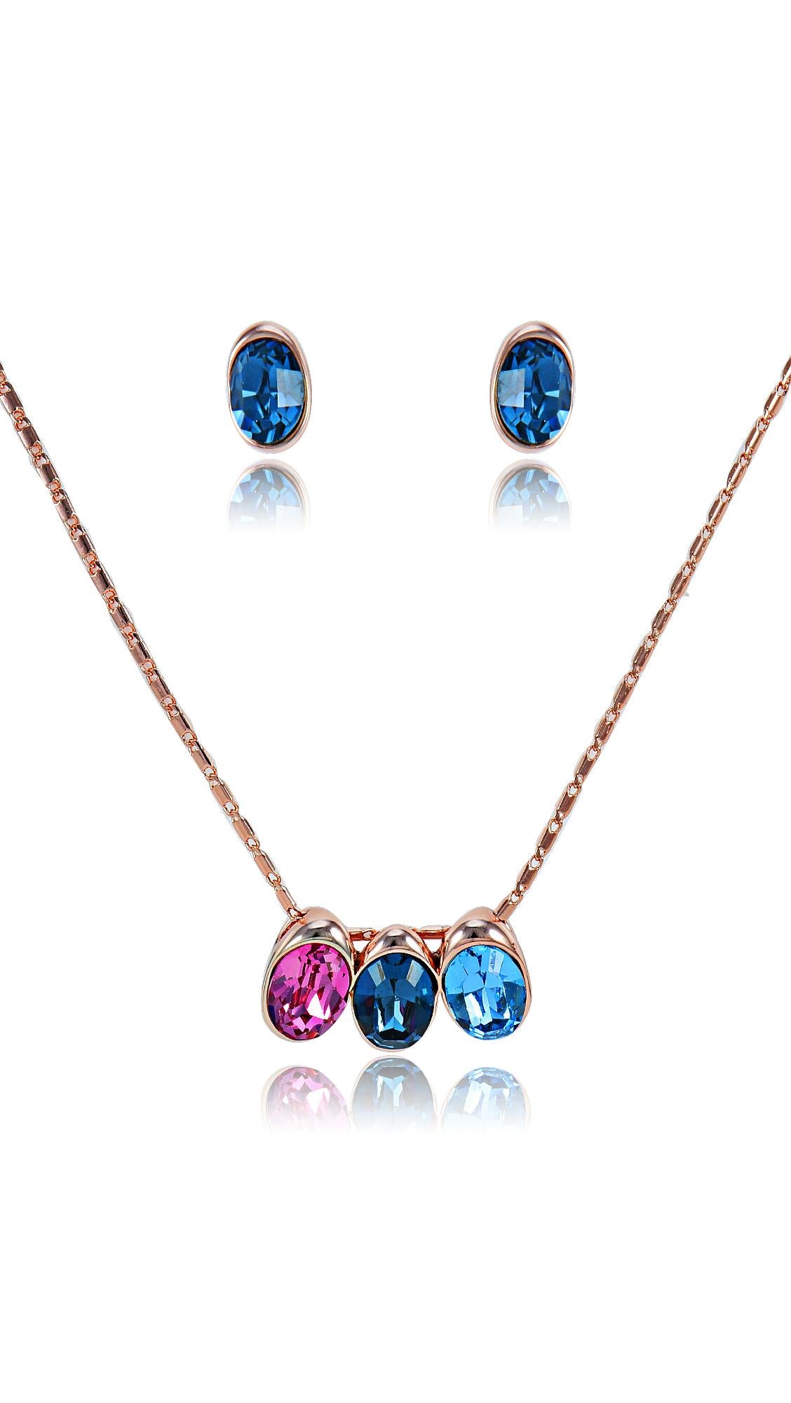 Swarovski Set Jewelry featuring a rose gold chain with colorful pink and blue crystal pendant and matching blue stud earrings. Elegant and dazzling style.