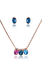 Swarovski Set Jewelry featuring a rose gold chain with colorful pink and blue crystal pendant and matching blue stud earrings. Elegant and dazzling style.