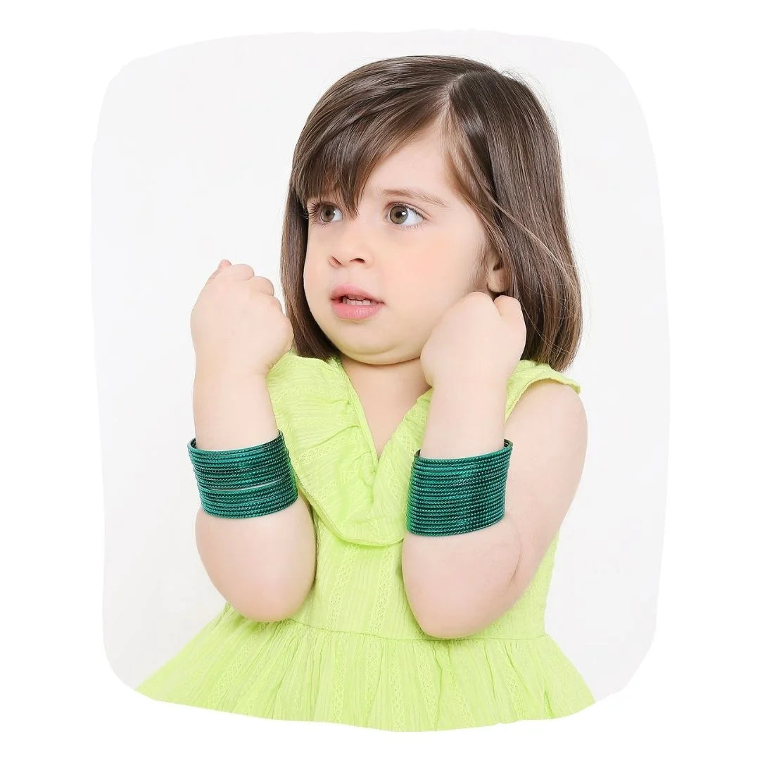Young girl wearing Green Metal Bangles Set (36 Pcs) from Arendelle, showcasing stylish and comfortable jewelry for kids aged 3 to 7 years.