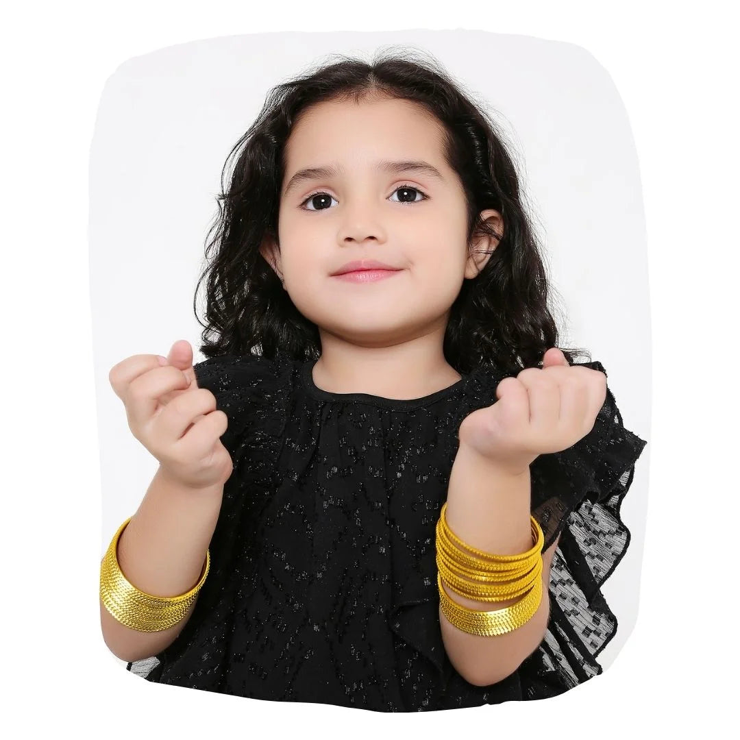 Young girl wearing Yellow Metal Bangles Set (36 Pcs) from the Traditional Indian Bangles collection, styled for festive or daily wear.