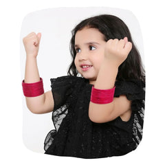 Young girl wearing Arendelle's Pink Metal Bangles Set - Traditional Metal Bangles | 36 Pcs, showcasing vibrant and elegant jewelry for kids.