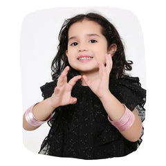 Young girl wearing Light Pink Metal Bangles Set - Traditional Jewelry | 36 Pcs, showcasing stylish accessories for kids in black dress.
