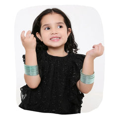 Young girl wearing Arendelle Kids mint green metal bangles set of 36, perfect for festive occasions and stylish outfits.