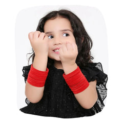 Young girl wearing Red Velvet Bangles Set from Arendelle, showcasing elegant traditional bangles in vibrant red for festive occasions.