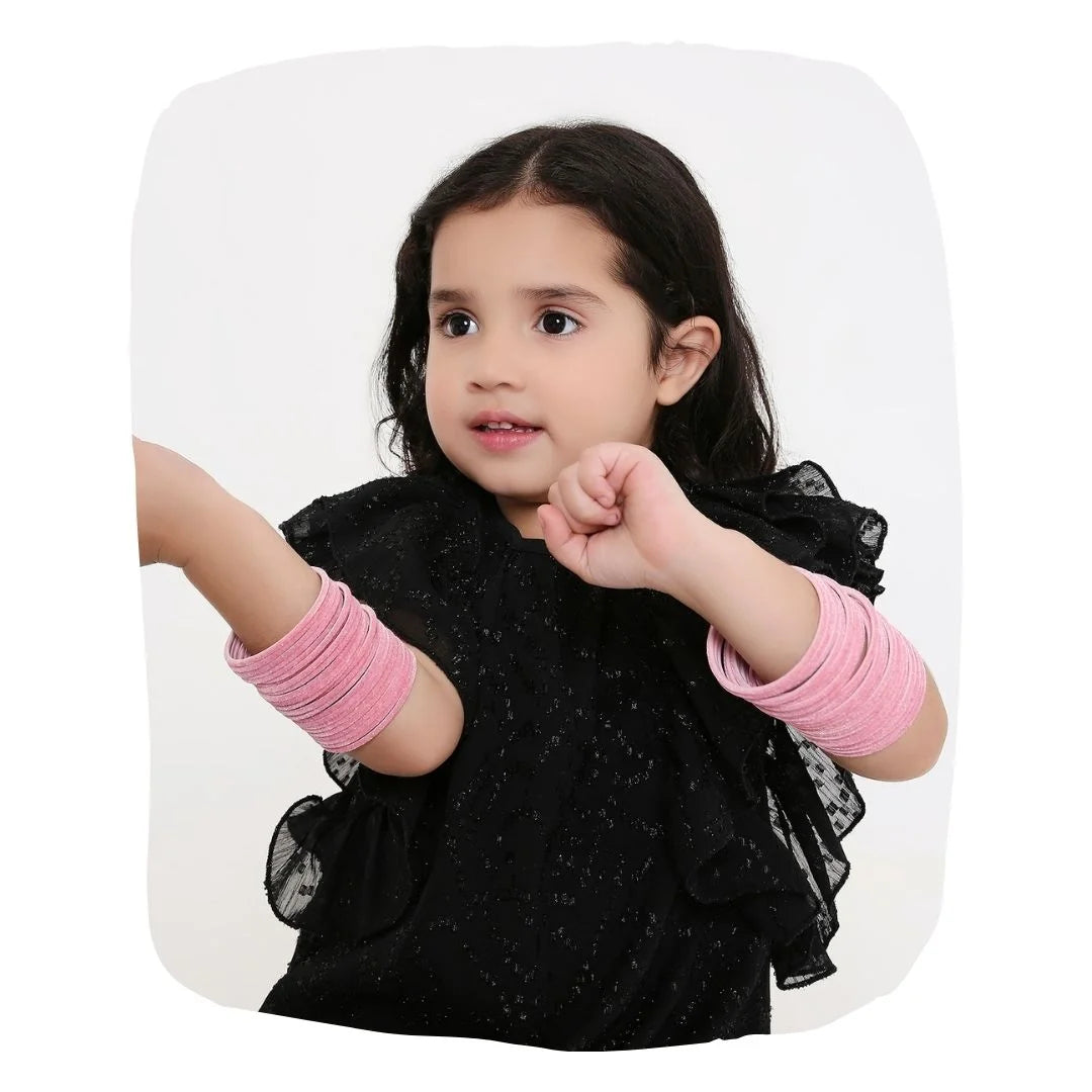 Young girl wearing Baby Pink Velvet Bangles Set of 48 pcs, showcasing lightweight and stylish jewelry from the Velvet Bangles Set collection.