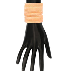 Peach Velvet Bangles Set - 48 Pcs displayed on mannequin hand, emphasizing elegant fit and smooth finish for jewelry lovers.