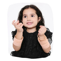 Young girl wearing Peach Velvet Bangles Set - 48 Pcs, showcasing soft and stylish bangles perfect for kids' daily wear or festive outfits.