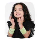 Young girl wearing pista green velvet metal bangles set of 48 pcs, showcasing stylish and comfortable jewelry for kids.