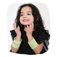 Young girl wearing pista green velvet metal bangles set of 48 pcs, showcasing stylish and comfortable jewelry for kids.