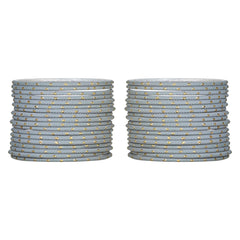 Close-up of 48 grey metal bangles for girls with gold accents, neatly arranged in two stacks. Elegant and durable bracelets by Arendelle Kids.