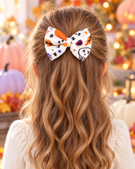 Girl wearing White Skull & Stars Halloween Hair Bow, half-up style