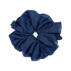 Close-up of navy blue organza scrunchie with Arendelle tag, highlighting soft, oversized design for chic and versatile hair accessorizing.