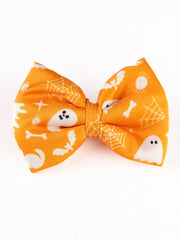 Front view of Orange Halloween Hair Bow with white ghost and web designs