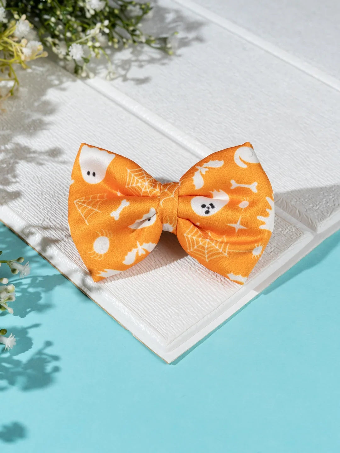 Orange Halloween Hair Bow with white ghost, spider web and bone motifs