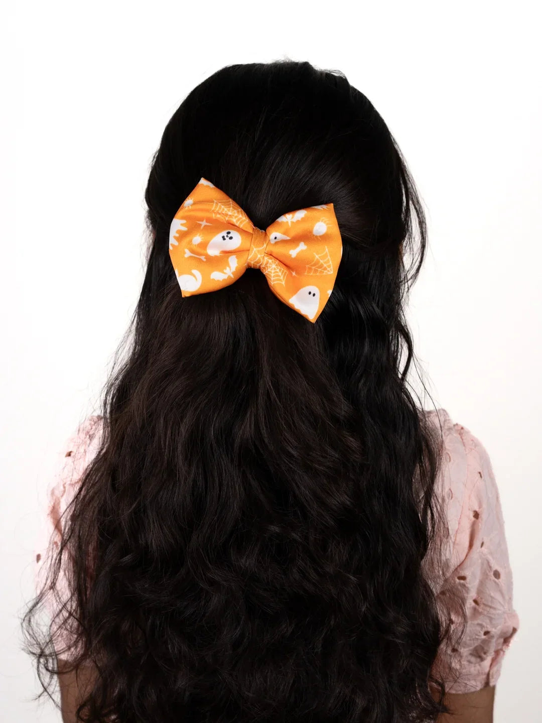 Girl wearing Orange Halloween Hair Bow with ghost and spider-web print