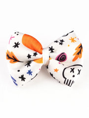 Front view of White Halloween Hair Bow with skull, stars and autumn leaves