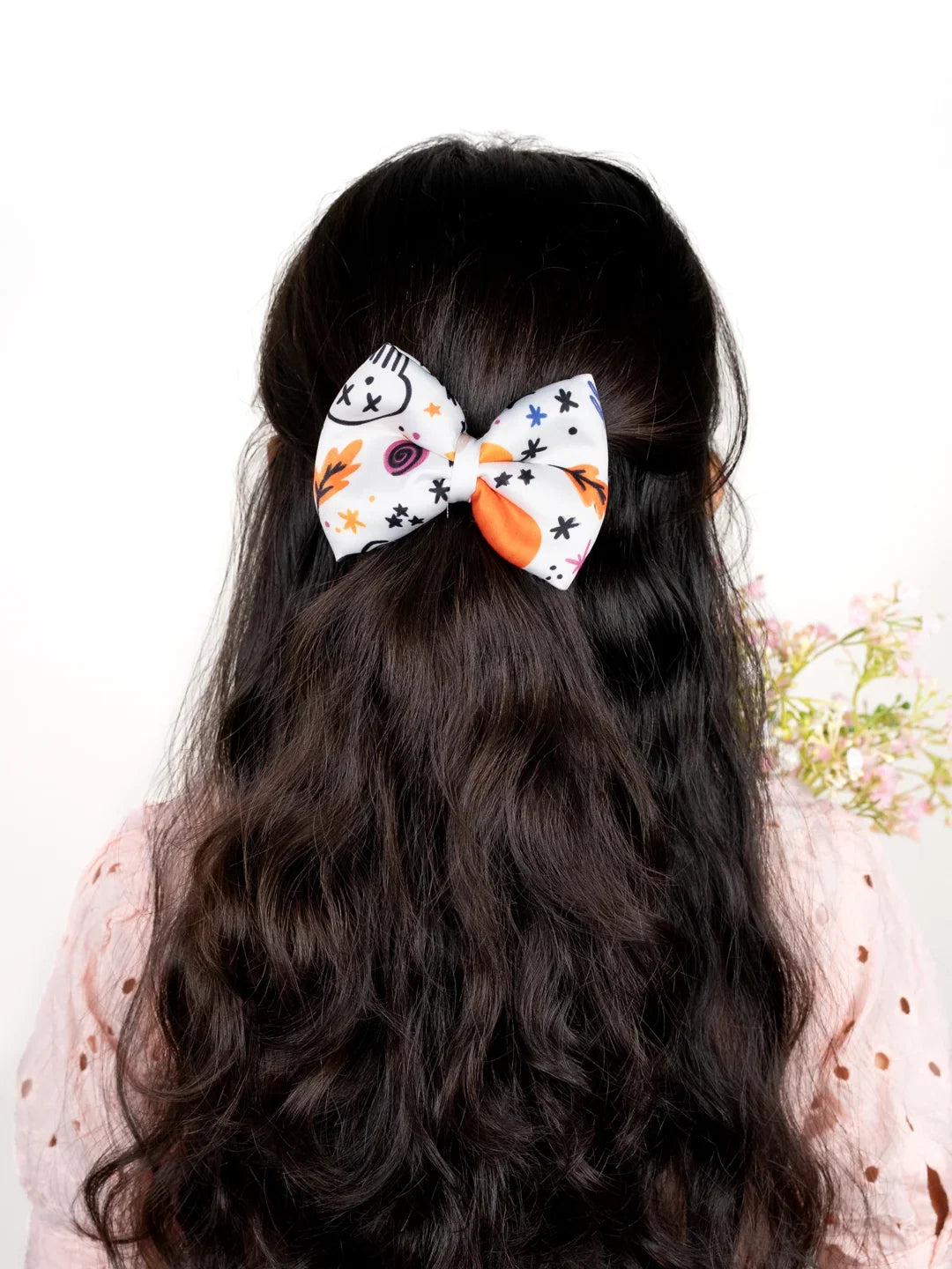 Girl wearing White Halloween Hair Bow with skull, stars and autumn leaves