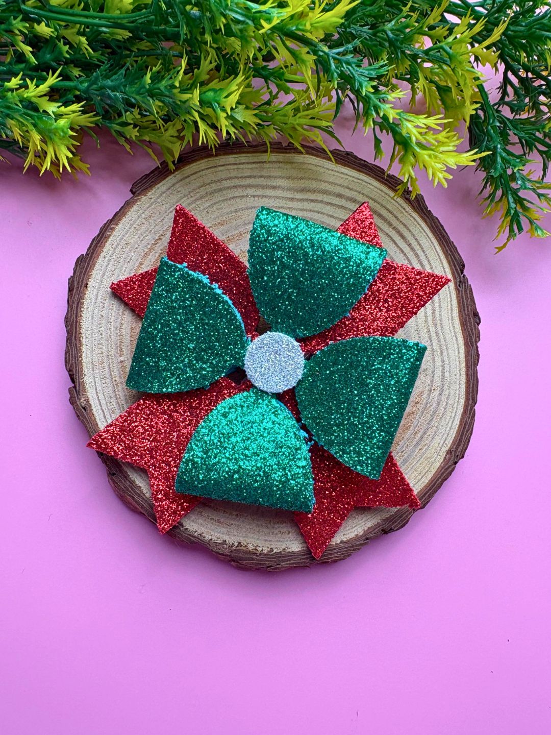 Festive Arendelle Glitter Hair Bow styled on wooden display with pink background, showcasing Christmas-themed sparkle for girls.