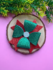 Festive Arendelle Glitter Hair Bow styled on wooden display with pink background, showcasing Christmas-themed sparkle for girls.
