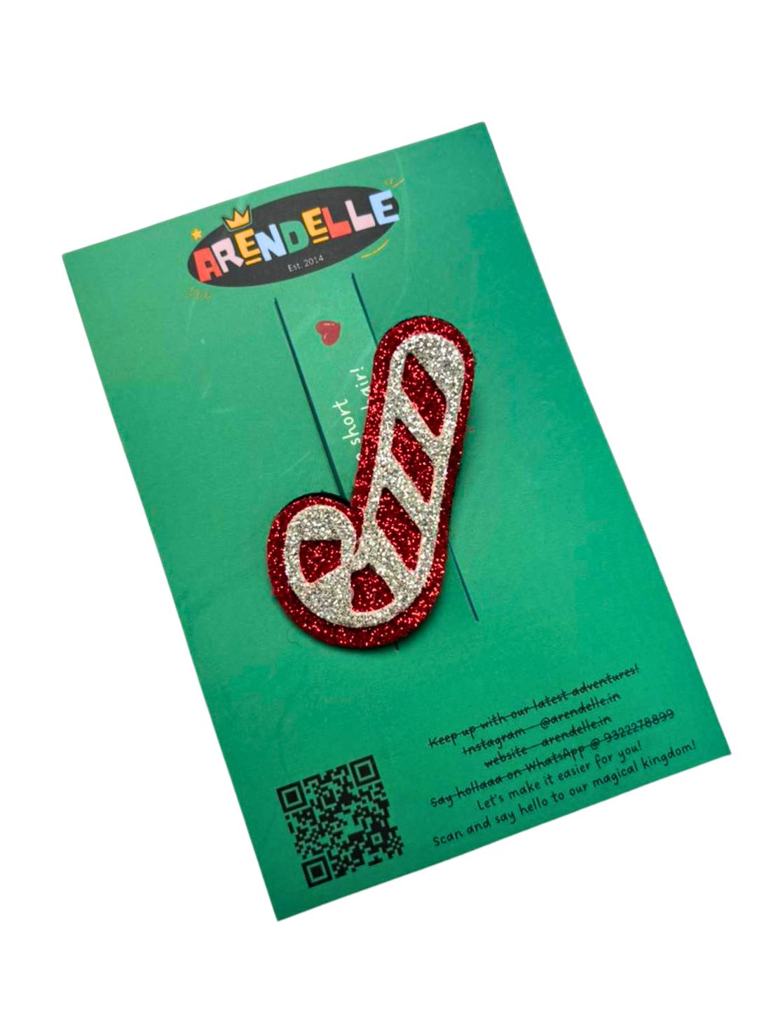 Candy cane glitter hair clip from the Festive Christmas Collection displayed on branded Arendelle packaging card.