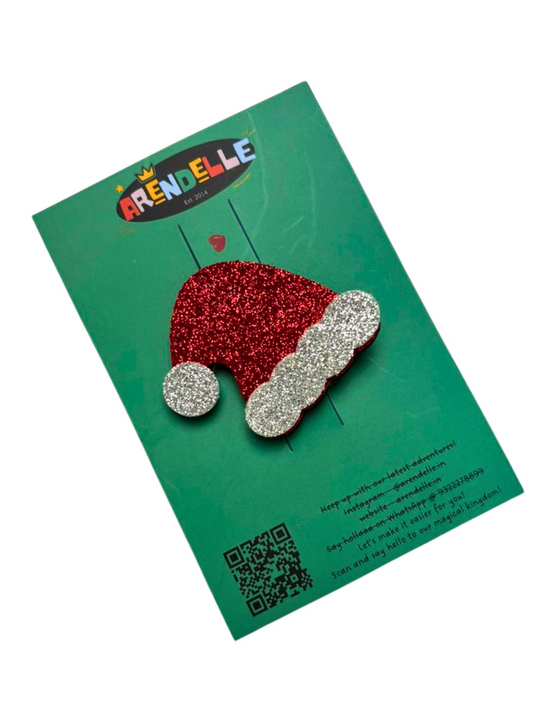 Festive Santa hat glitter hair clip on branded Arendelle packaging, part of the Christmas Glitter Hair Clips & Bows collection.