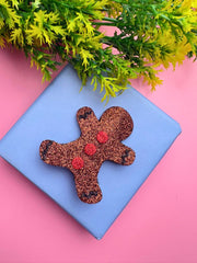 Gingerbread man-shaped Christmas Glitter Hair Clip displayed on a gift box with festive decor, ideal for holiday styling and accessories.