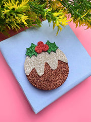 Sparkly Christmas Glitter Hair Clip styled on a gift box, featuring festive holly leaves and pudding design for holiday accessories.