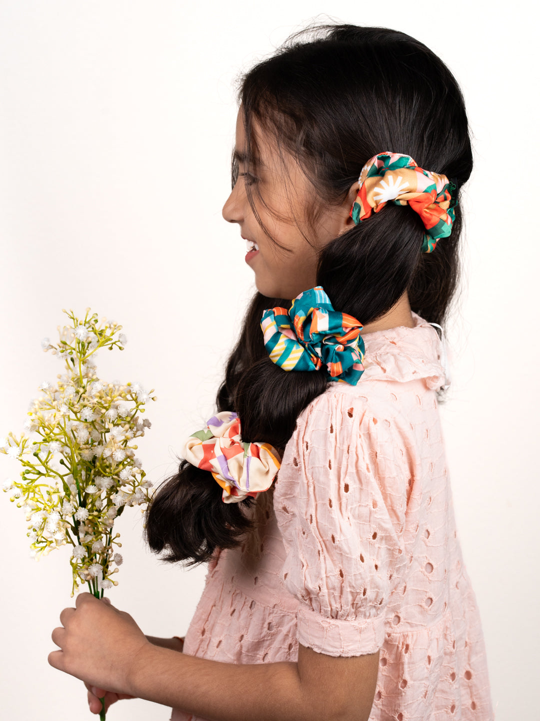 Young girl wearing Christmas Glitter Hair Accessories scrunchies in her hair, showcasing festive and playful holiday styles for kids.