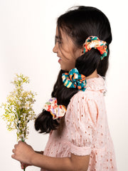 Young girl wearing Christmas Glitter Hair Accessories scrunchies in her hair, showcasing festive and playful holiday styles for kids.