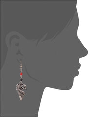 Fashionable dragon earrings on a woman's ear