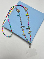 Arendelle Phone Sling - Navratri Special with colorful beads and shells, displayed on a blue box. Ideal for festive traditional outfits.