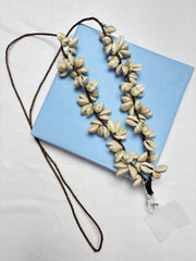 Arendelle Phone Sling - Navratri Special with cowrie shells and beaded detailing, displayed on a blue box. Ideal for ethnic festive wear.