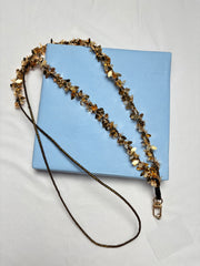 Navratri Phone Sling - Arendelle Hamza Hand with gold leaf embellishments on a blue box. Festive accessory for traditional outfits.