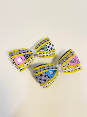Close-up of Pari Hoon Main Bow Clip Set featuring multicolored crochet bows with silver accents, ideal festive hair pins for Navratri celebrations.