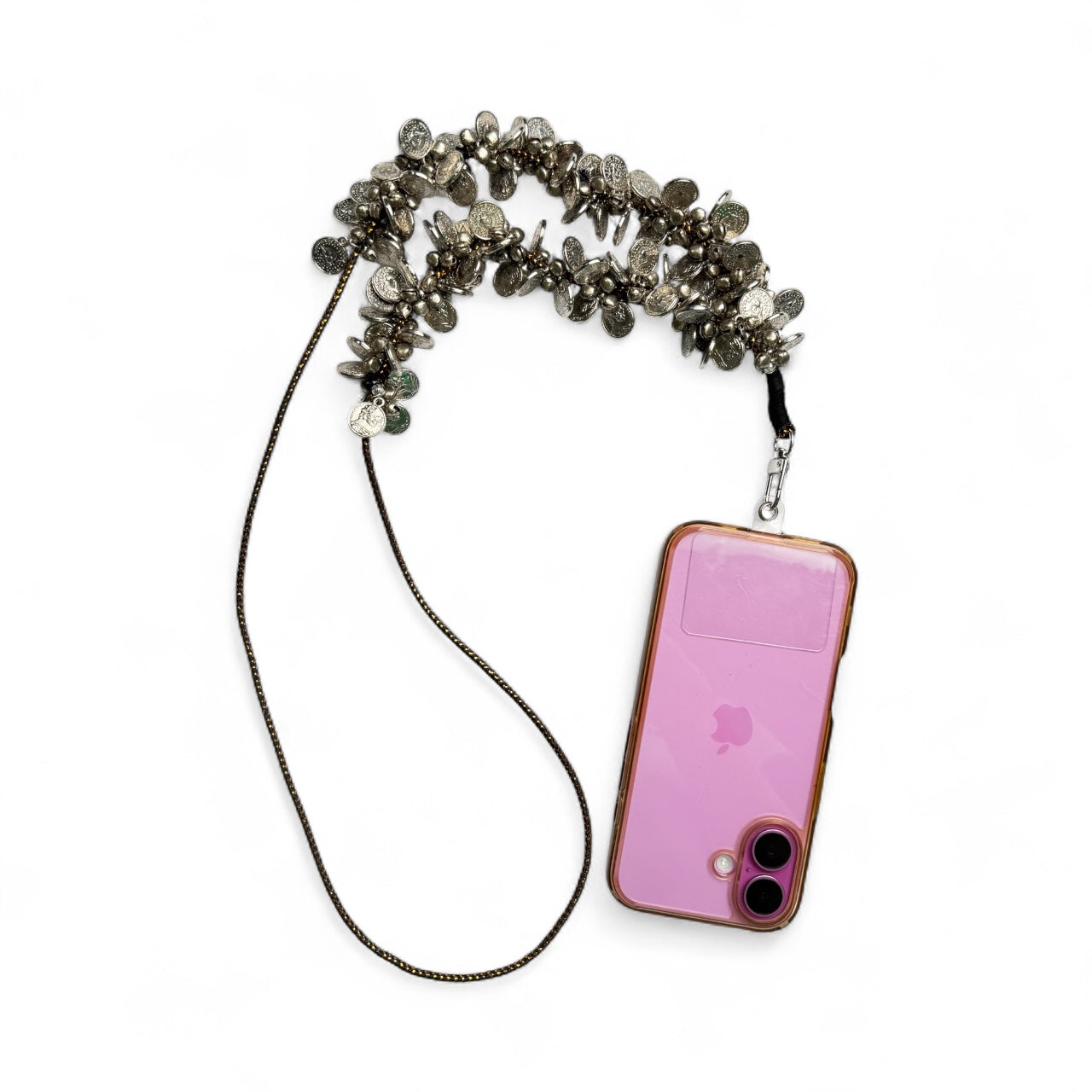Arendelle Coins Sling - Navratri Style attached to a pink smartphone, blending festive charm with practical phone accessory design.