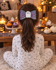 Girl in ghost pyjamas wearing the Lilac Boo hair bow