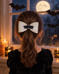 Girl by a moonlit window wearing the Moonlight Bat hair bow