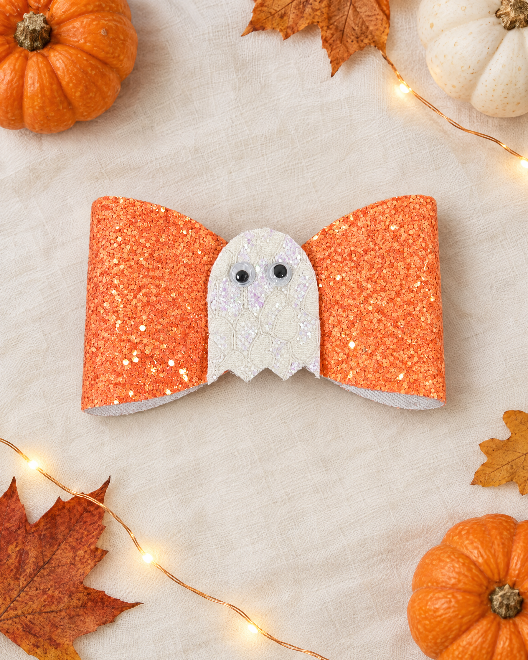Little Boo Halloween hair bow flat lay with mini pumpkins