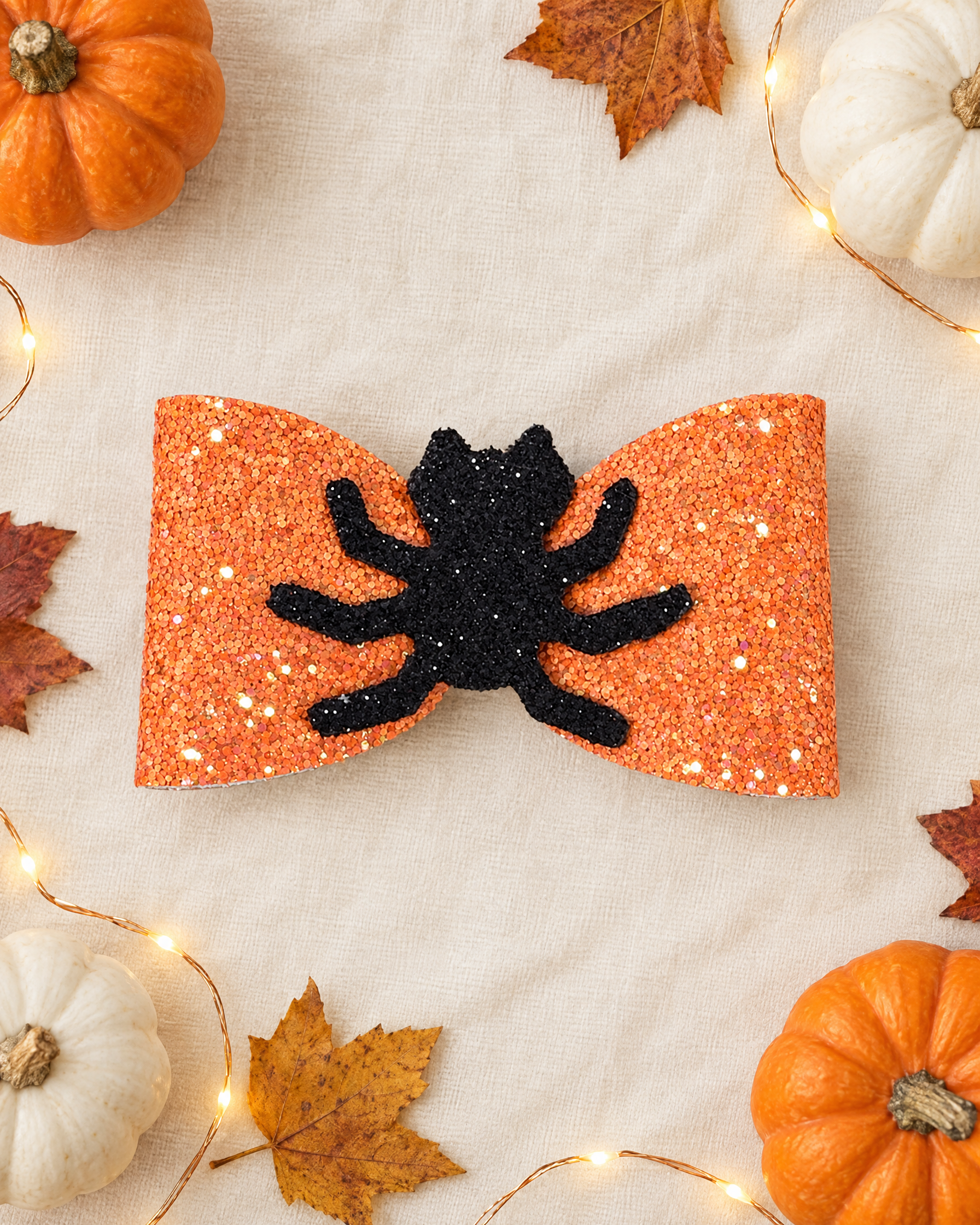 Itsy Spider Halloween hair bow flat lay with mini pumpkins