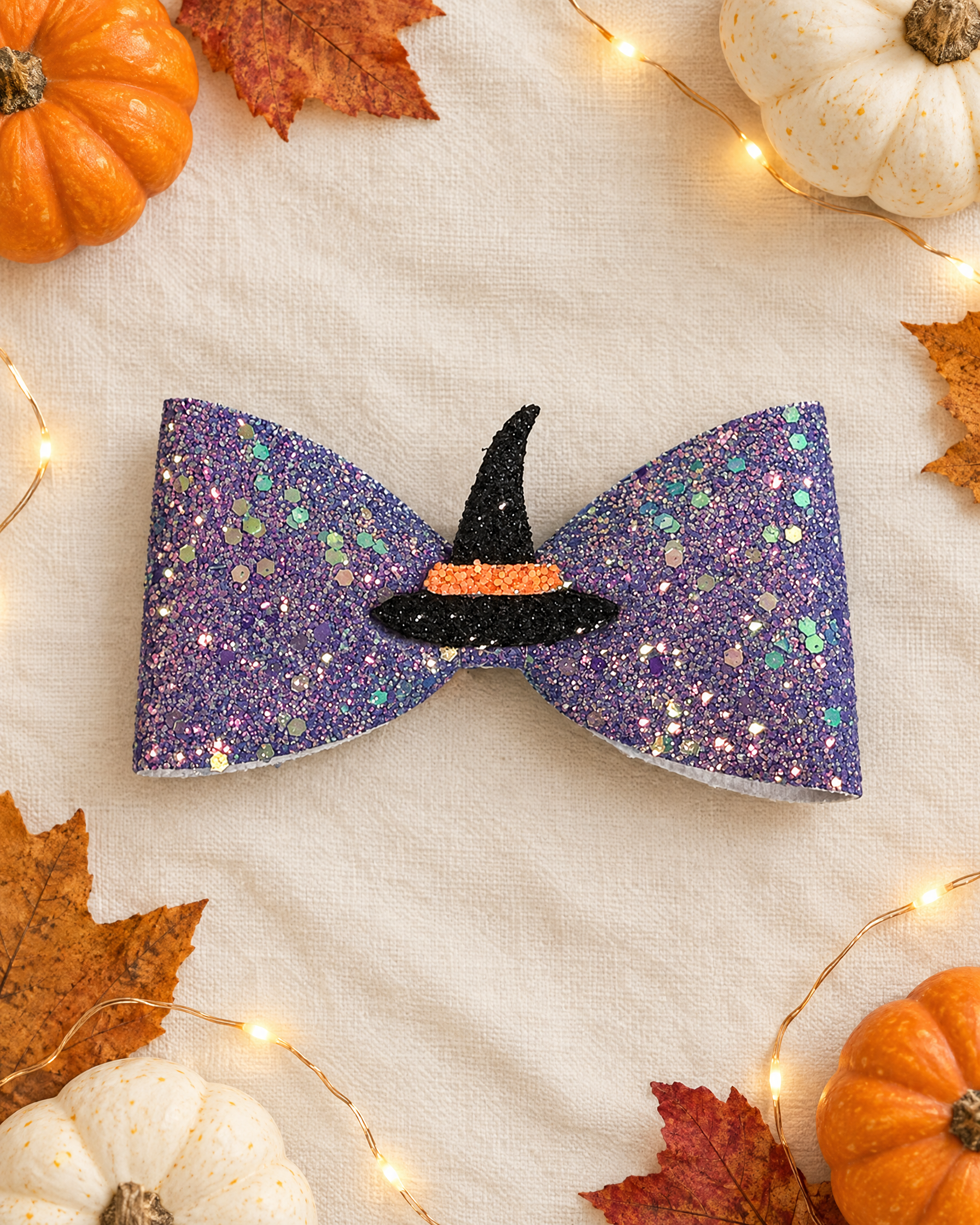 Witchy Lilac Halloween hair bow flat lay with mini pumpkins