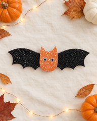 Batty Wings Halloween hair clip flat lay with mini pumpkins