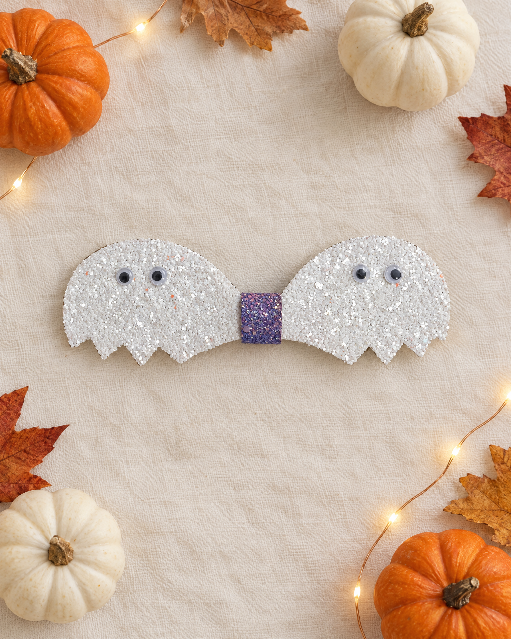 Ghostie Pair Halloween hair clip flat lay with mini pumpkins