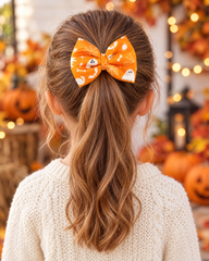Girl wearing Orange Ghost & Spider Web Halloween Hair Bow in a ponytail